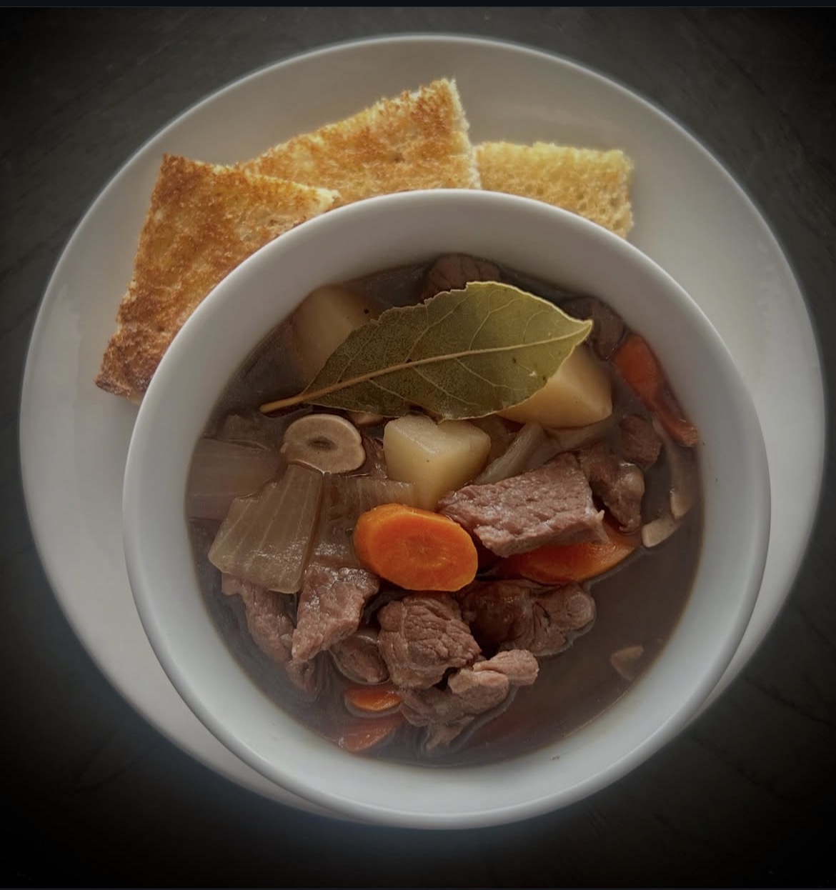 A hearty chef-prepared stew with toast